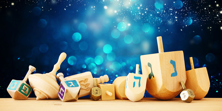 The dreidel's Hebrew letters nun, gimmel, hey and shin stand for Nes Gadol Haya Sham (A great miracle happened there)