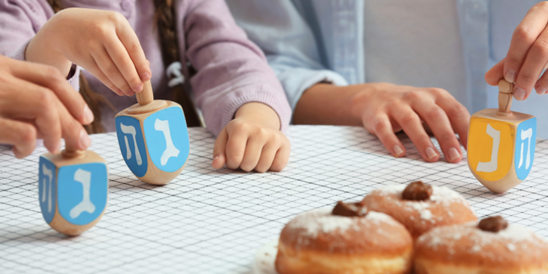 We light candles, eat doughnuts and sing Chanukah songs